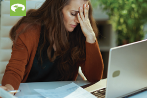 woman looking stressed out at a laptop