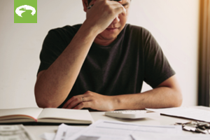 Man looking at bills and looking distressed