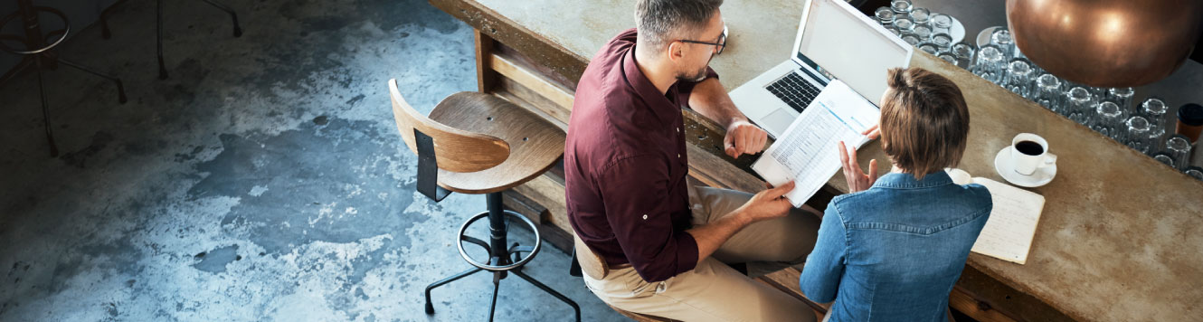 two business partners looking a documents