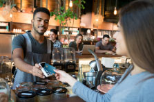 woman using credit card at a shop