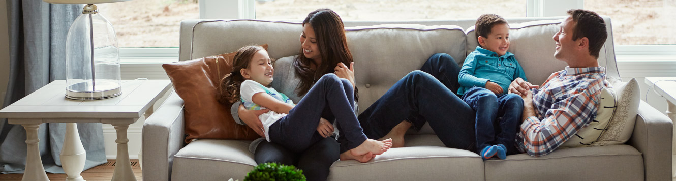 a family sitting on the couch together