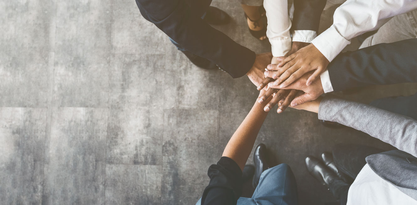 team with all hands in