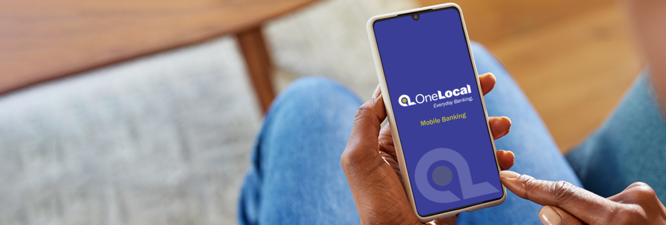 person holding phone with OneLocal Bank logo on it