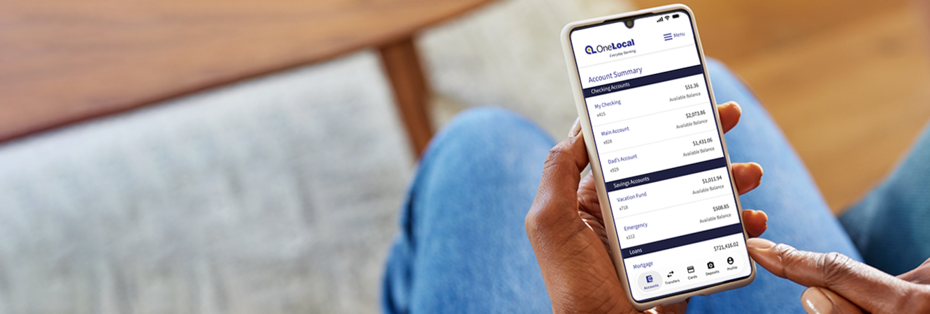 person holding phone and using mobile banking