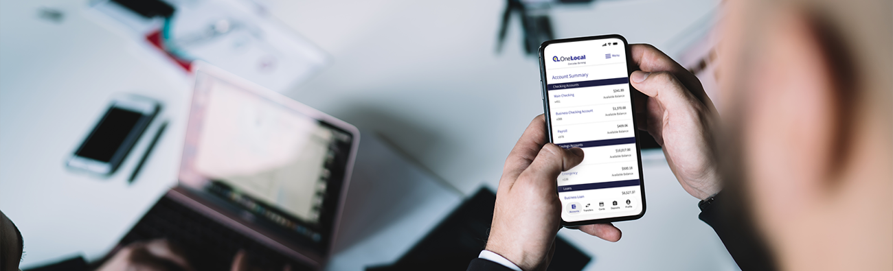 Business owner holding phone and using business mobile banking
